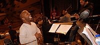 MYRON BUTLER DIRECTS THE BACKGROUND SINGERS...